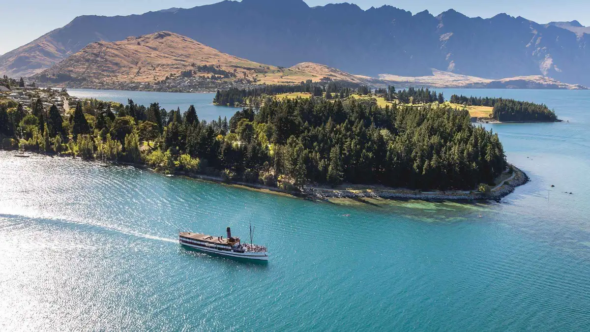 The coal-fired steamship at the wharf with the Remarkables behind — TSS Earnslaw Lake Wakatipu cruise, Queenstown, New Zealand